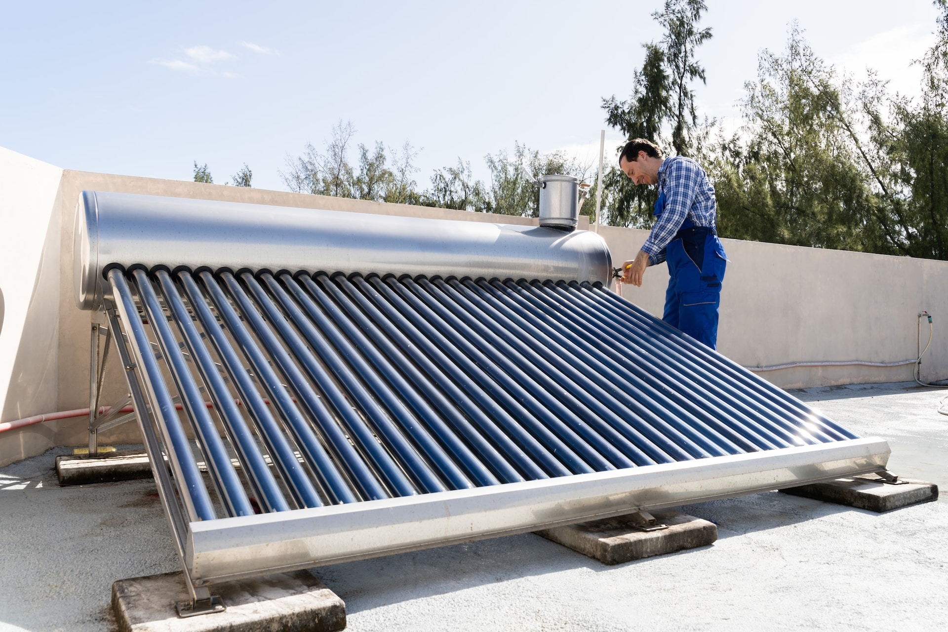 Man working on solar panel on roof