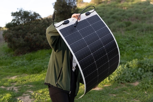 Person holding thin-film solar panel