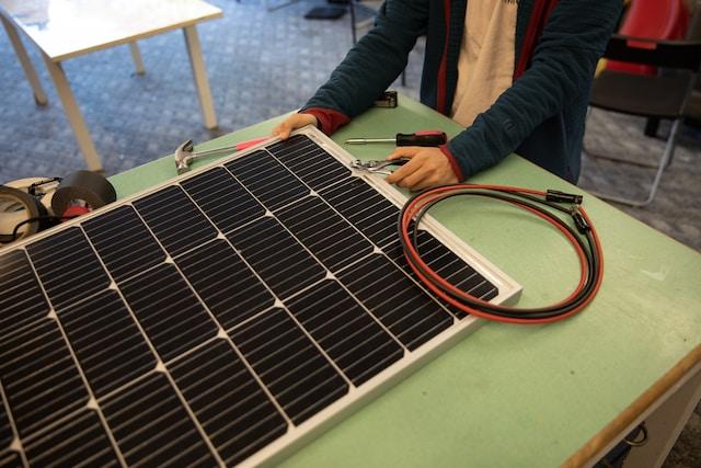 Person working on solar panel